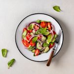 Green vegan salad from vegetables and green leaves mix.