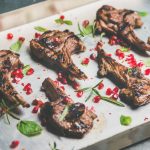 Grilled lamb ribs with pomegranate seeds and fresh herbs