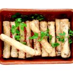 Moroccan cigars in ceramic bowl isolated on white