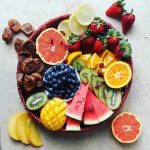 overhead view of healthy food fruit platter on stone table