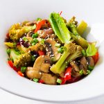 Stir fry vegetables with mushrooms, paprika, red onions and broccoli. Healthy food. Asian cuisine.