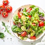 Green salad, Fresh salad leaves and vegetables in white plate.