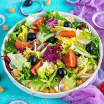 Vegetarian salad with chickpeas, tomatoes, olives and lettuce. Diet salad food